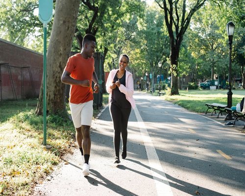 Senior couple running jogging in autumn park happy